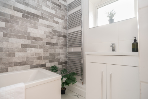 Clean and crisp white master bathroom, recently decorated and perfectly maintained for a fresh, hotel-quality feel.