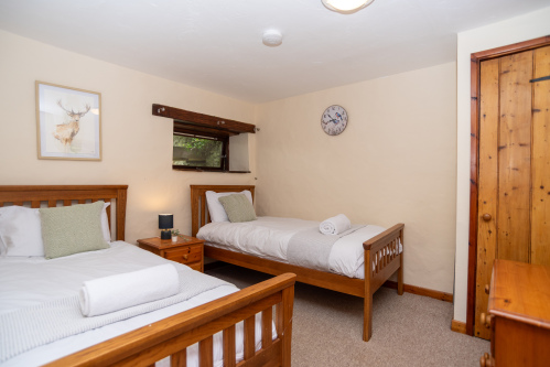 Twin Room with Ample Storage - Well-appointed twin bedroom with wardrobe and the character original mill window, ideal for two guests sharing