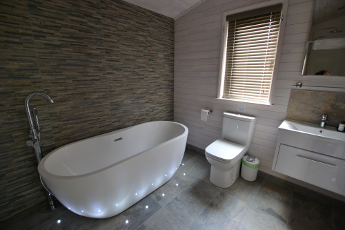 Luxurious bathroom with sauna and freestanding bath