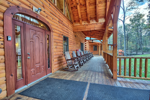 Front Porch Rockers, with Conference Room and Kids' Playset beyond, Majestic Oaks Lodge