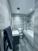 Modern bathroom with rainfall shower and egyptian cotton towels. 