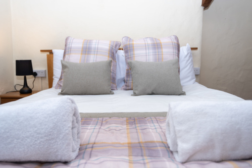 Soft linens, plush furnishings and thoughtful styling create a restful space designed for a relaxing holiday stay.