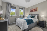 Double Bedroom with blackout blinds and curtains, and double wardrobe, chest of drawers and bedside tables
