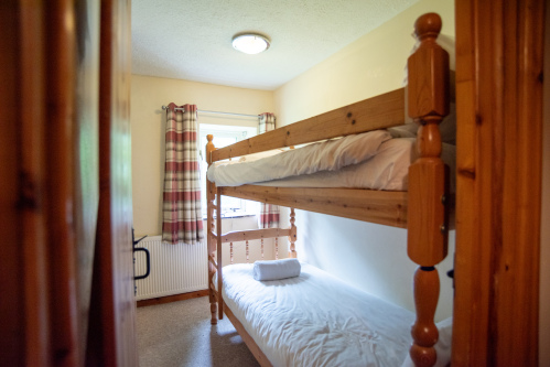 Bunk Room, Sleeps Two - Pine bunk beds with fresh white linens and towels provided, perfect for kids or extra guests joining the group.