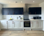 Modern kitchen with all appliances and amenities.