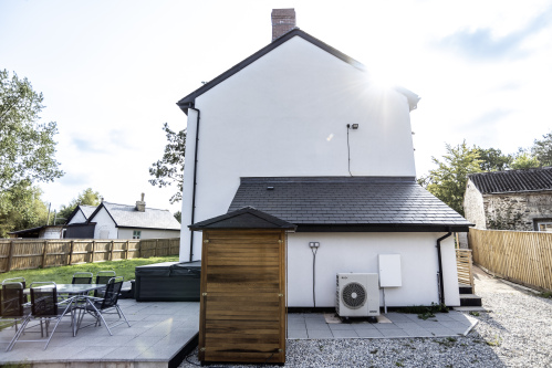 Perfect Outdoor Setup - Hot tub, sauna, garden seating, bistro table and private driveway, ideal for relaxing or entertaining guests