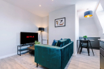 A spacious and inviting living room perfect for relaxing and socialising. Enjoy a comfortable atmosphere with stylish furnishings and ample space to unwind after a day of exploring.
