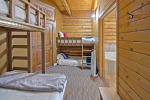 Spacious family suite with multiple beds and rustic Western charm.