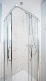 Clean, fresh and bright modern fitted bathroom, with walk in shower large mirror and a snuggly warm towel radiator.