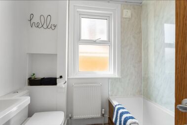 Family bathroom with shower over bath