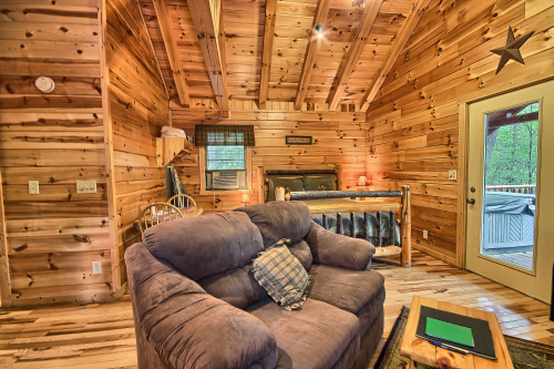Loveseat and Queen Bed, with door to Back Deck