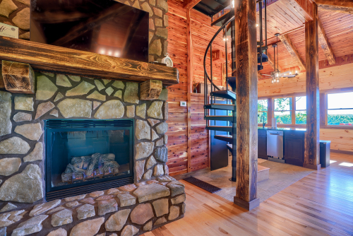 View from Couch, toward Fireplace, Spiral Staircase , Kitchen, Soaring Eagle Luxury Treehouse