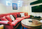Living room: Comfy seating area with Smart TV
