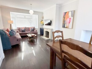 Unwind in this elegant living room, featuring two cozy two-seater sofas and a sleek TV. With warm lighting and stylish décor, it’s the perfect spot to relax after exploring.