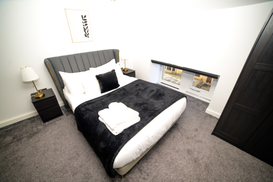 Settle into this serene double bedroom — a peaceful space to recharge.