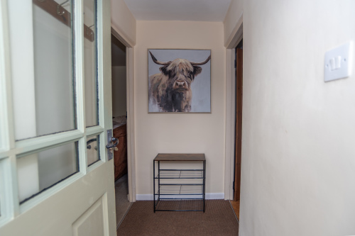 Welcoming Entrance Hall, complete with our lovely Highland cow and handy shoe storage to greet you on arrival