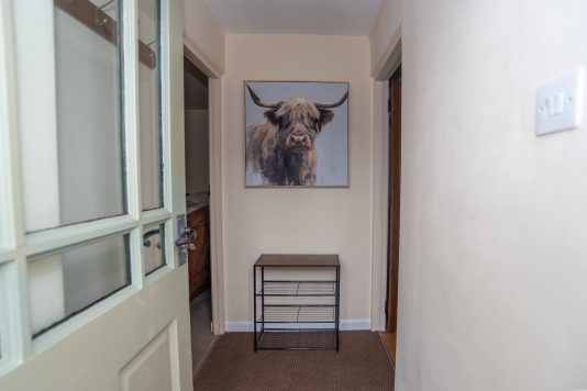 Welcoming Entrance Hall, complete with our lovely Highland cow and handy shoe storage to greet you on arrival