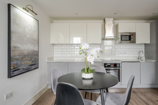 An elegant dining area designed for memorable gatherings, featuring a statement dining table, sophisticated seating, and ambient lighting. This refined space blends style and comfort, perfect for both intimate meals and grand entertaining.