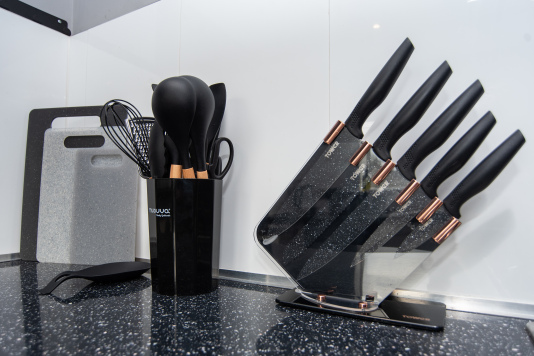 Fully stocked with knife block, utensils, and chopping boards — everything you need for easy meal prep during your stay.