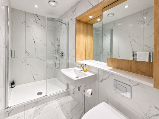 Walk-in shower
Stylish walk-in shower finished with elegant marble-effect tiles, a rainfall shower and polished chrome fittings for a luxurious, hotel-inspired feel.