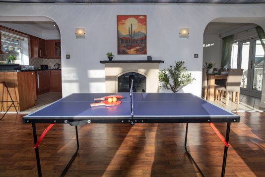 ping-pong table in the conservatory games room, ideal for family fun, friendly competitions, and keeping everyone entertained