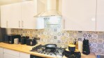 Brand new kitchen with utensils, new washing machine, fridge, microwave, oven, kettle, toaster, coffee, tea, sugar, milk