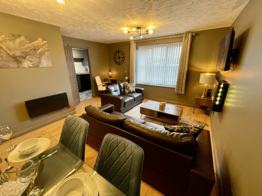 Open plan living area with flat screen TV and fireplace