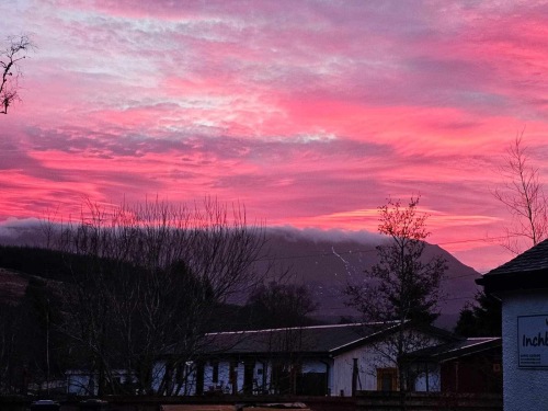 View from rear grounds to setting sun over ullapool