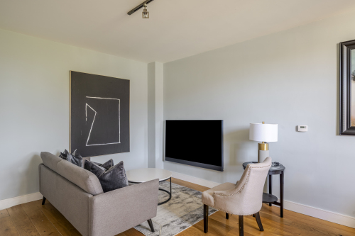 Experience refined comfort in this beautifully designed living room, where sophisticated décor meets effortless elegance. Flooded with natural light, the space features plush seating, stylish accents, and a statement centrepiece that elevates every moment. Perfect for relaxing or entertaining, this room delivers luxury living at its finest.