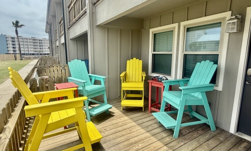 Bar height patio seating gives you a great view of the pool and greenspace 