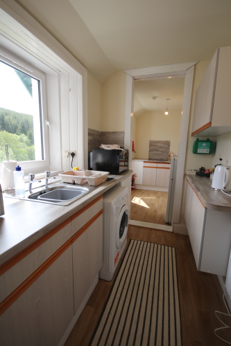 kitchen with view from window and washing machine