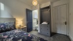 This single bedroom is the perfect choice for solo travellers who don't want to compromise on comfort. Featuring a comfortable single bed, a spacious wardrobe, and your own en-suite shower, it's a private retreat within a larger 7-bedroom house. We've also included a kettle with tea and coffee so you can enjoy a hot drink without leaving your room. With high-speed Wi-Fi throughout the house, two fully stocked kitchens, and an outdoor area to enjoy, this stay has everything you need for a memorable visit.