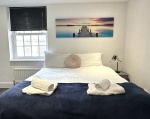 Beautiful large bedroom with stunning natural light, smart TV, desk with ergonomic chair, on-suite bathroom with walk in shower, lamp, built in wardrobe, chest of draws and everything else you need for a perfect stay!