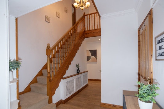 Welcoming entryway and staircase, creating a warm first impression on arrival.