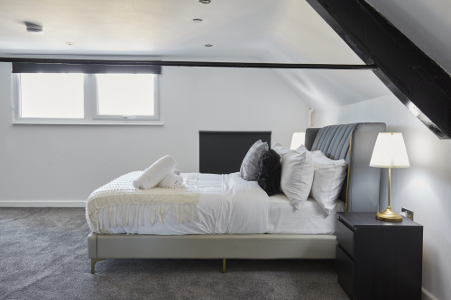 Sleep easy in this spacious double bedroom with soft linens and a relaxing ambience.