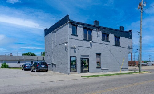 The building is on a large corner lot with a grass lot in the back.  You will park in the back lot. 