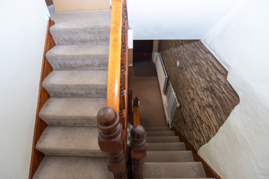 The cottage's traditional layout features a charming first-floor landing connecting the bedrooms and family bathroom.