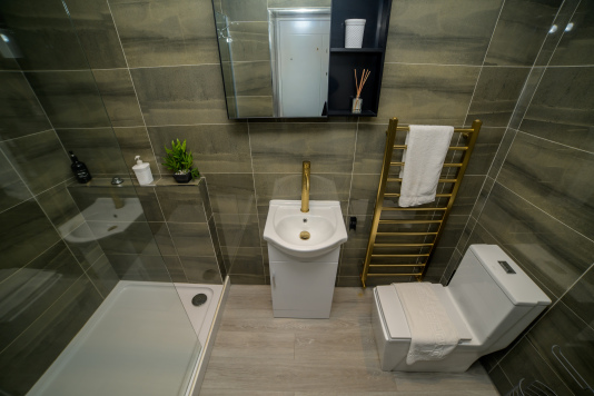 A fresh, well-maintained bathroom with essential amenities provided.