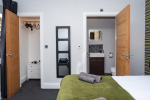 Ensuite bedroom with a private walk-in closet, offering added space and a touch of luxury for longer stays.