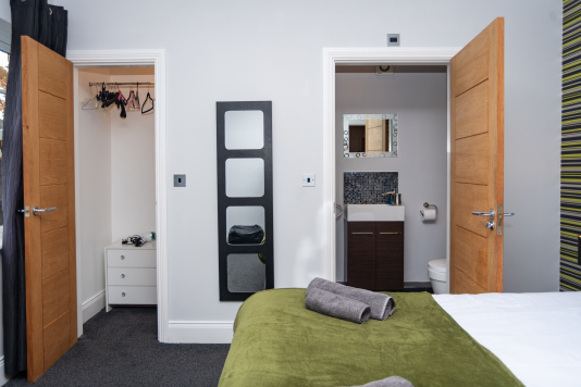 Ensuite bedroom with a private walk-in closet, offering added space and a touch of luxury for longer stays.