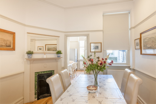 The Dining room located between the living room and kitchen with seating for 11 guests. 