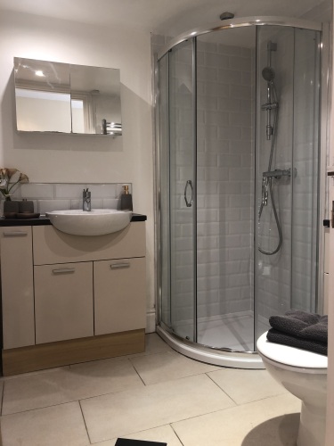 Family bathroom with corner bath and separate shower cubicle
