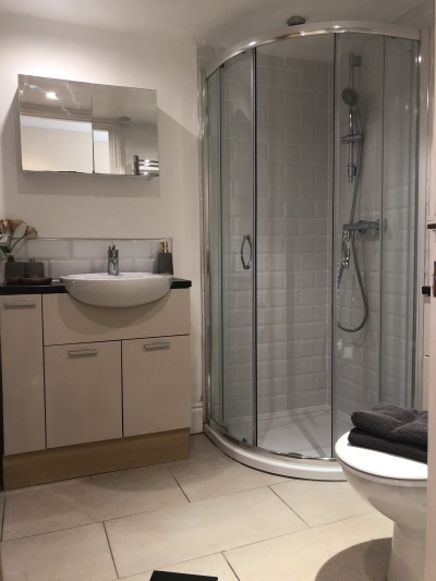 Family bathroom with corner bath and separate shower cubicle