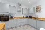 Stylish grey gloss kitchen with dishwasher, oven, fridge freezer and washer dryer
