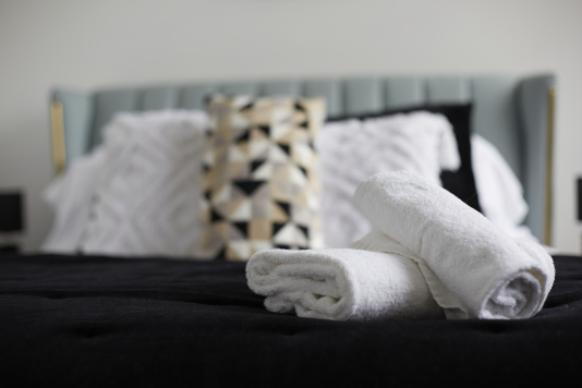 Sleep easy in this spacious double bedroom with soft linens and a relaxing ambience.