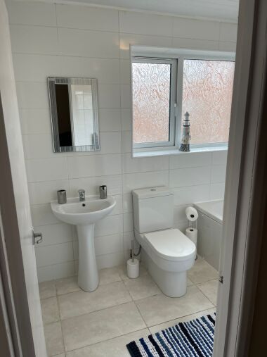 Spacious bathroom with sink, toilet, bath and overhead shower
