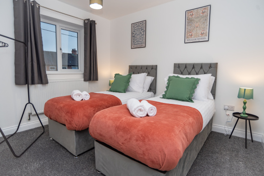Bright, comfortable room with two single beds — perfect for colleagues or guests sharing a space while still enjoying their own bed.