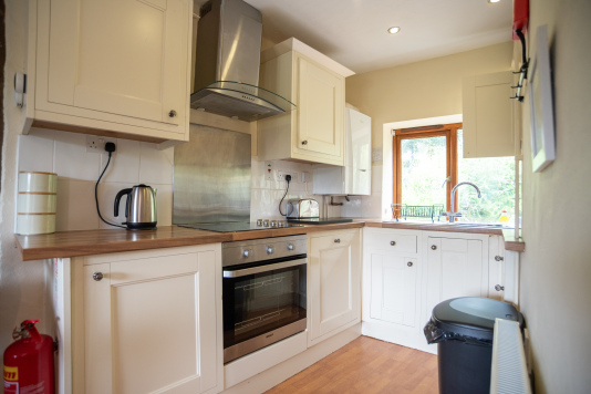 Fully equipped kitchen with oven, hob, microwave and ample preparation space for family meals and holiday favourites.