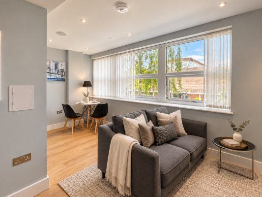 Living and dining area
Bright, contemporary living space featuring comfortable seating, warm wood flooring and a compact dining area beside large windows offering abundant natural light.