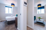 Spacious living room with comfortable seating and inviting atmosphere, perfect for relaxing or socialising during your stay.
